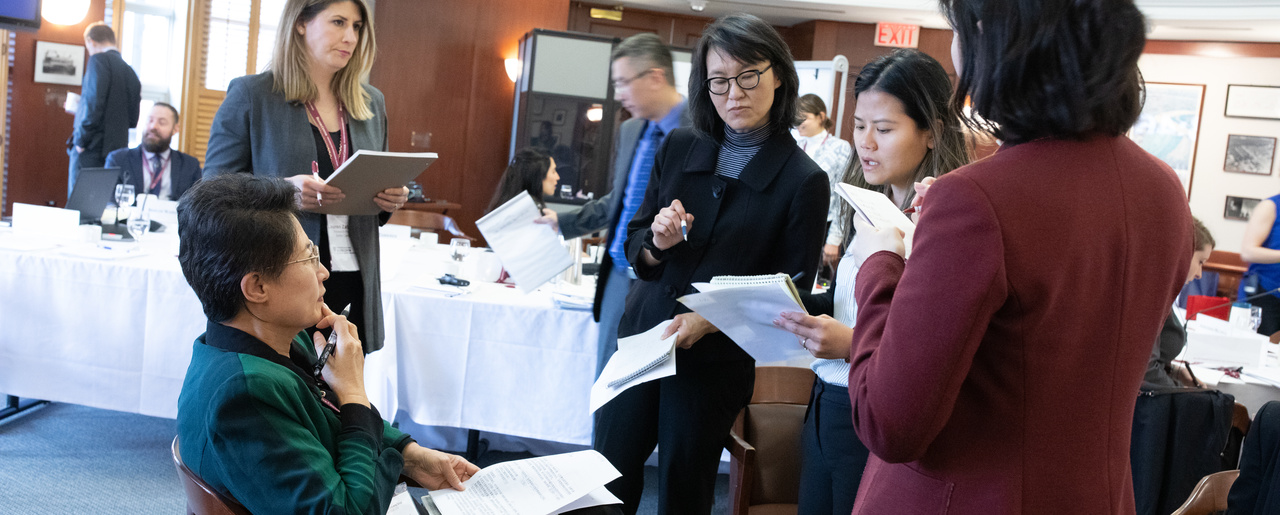 General Hao Yeli (second from left) and colleagues from the China working group discuss responses during the fictitious cyber scenario of a third party attack on critical infrastructure.